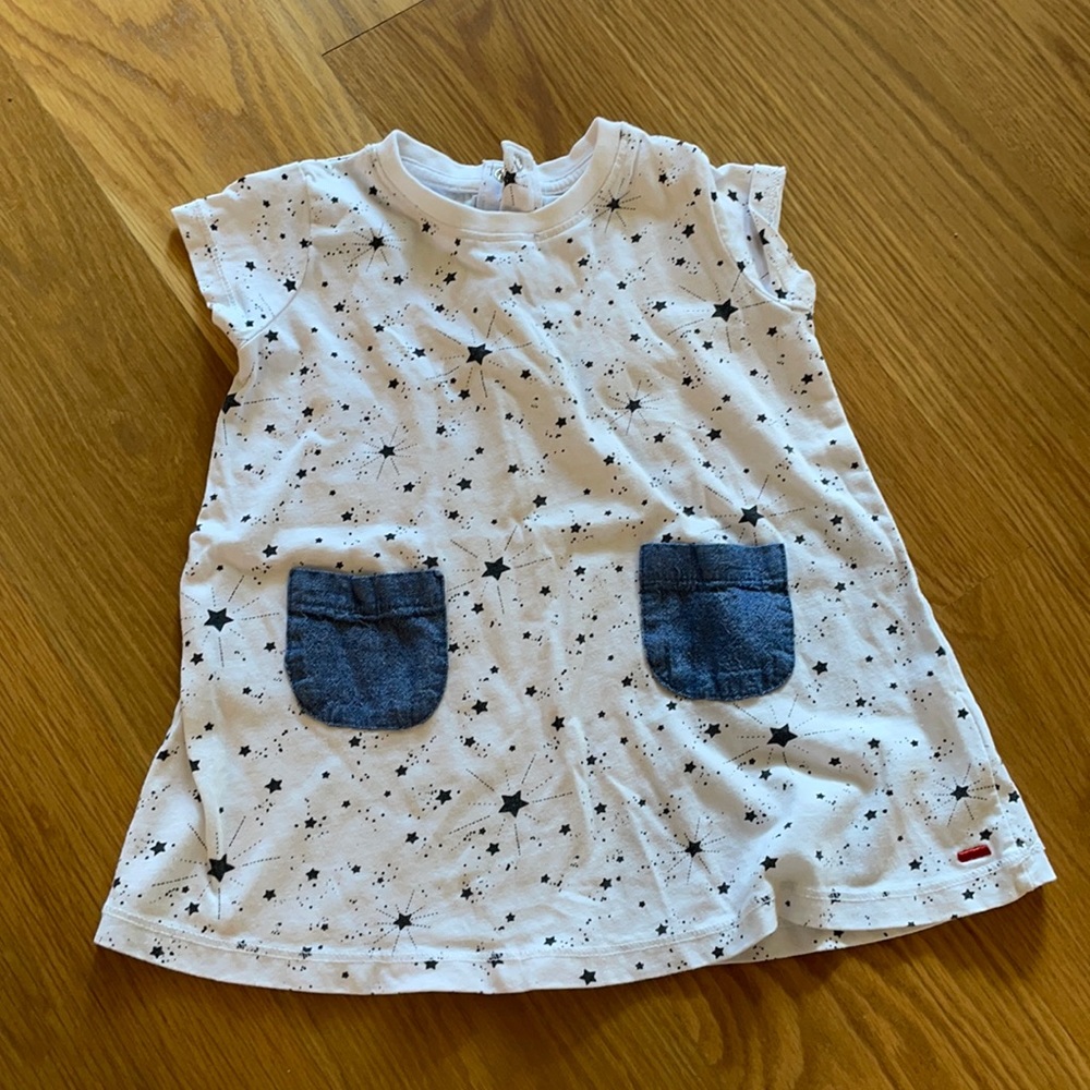 White dress with black stars and denim pockets.